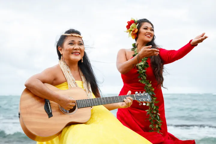 a woman standing next to a body of water