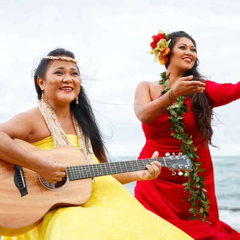 a woman standing next to a body of water