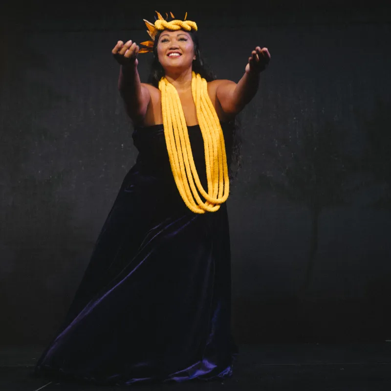 a woman wearing a yellow necklace